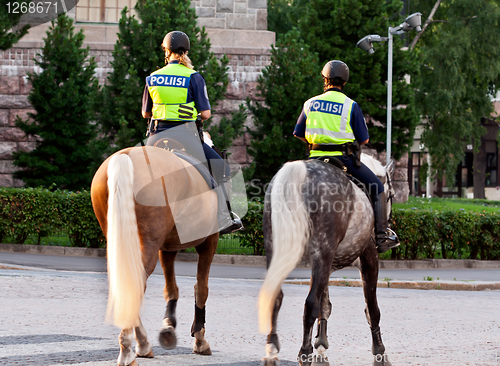 Image of Two girls policeman on a horse