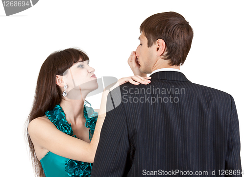Image of beautiful girl pulls the nose businessman