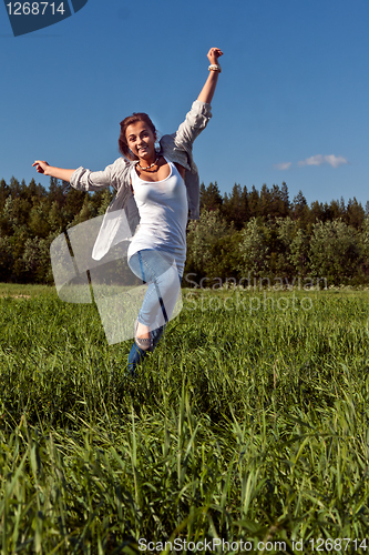 Image of girl runs across the green grass