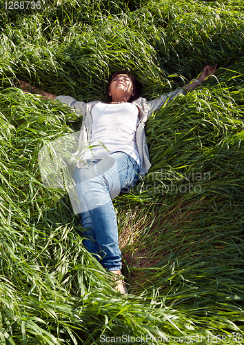 Image of girl lying in the green grass
