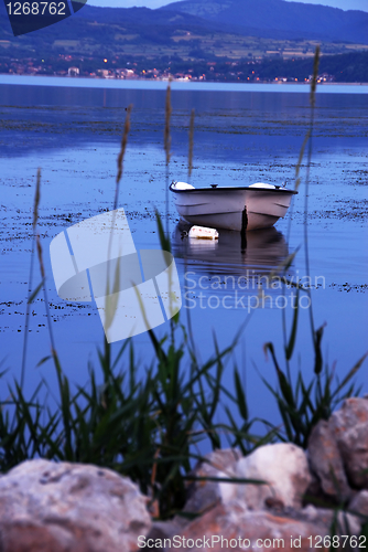 Image of Lonely boat on blue river
