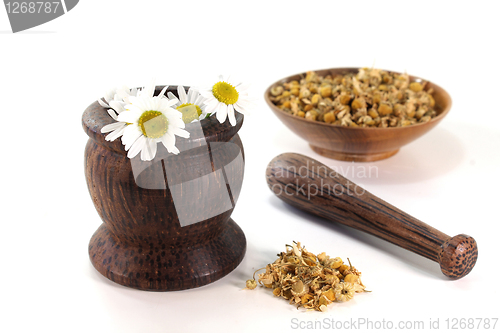 Image of chamomile flowers with mortar