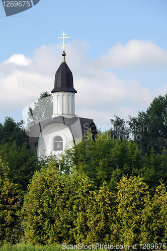 Image of White Chapel Surrounded by Green Trees