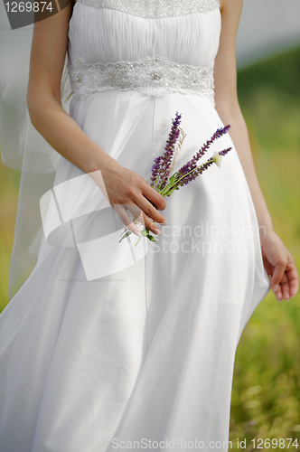 Image of Photography of a bride holding bouquet, Side View