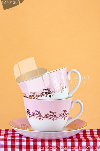 Image of Two retro style teacups on gingham cloth