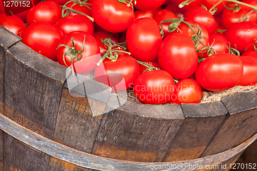 Image of Fresh red tomatoes in a wooden bucket