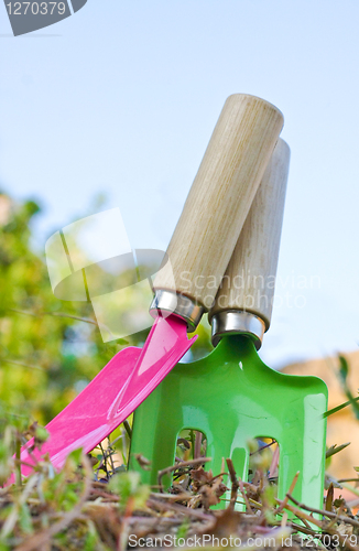 Image of Children's spade and trowel in a garden