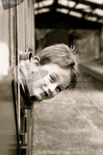 Image of Little boy leaning out of a train window