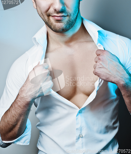 Image of Sexy Male Model Unbuttoning His White Shirt