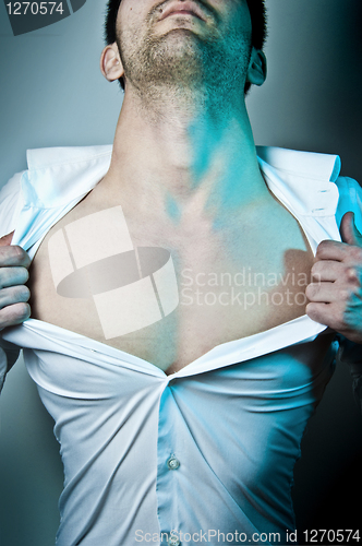 Image of Man tearing his shirt