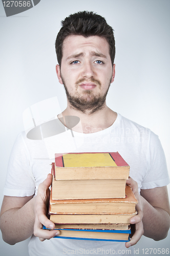 Image of Sad student holding books