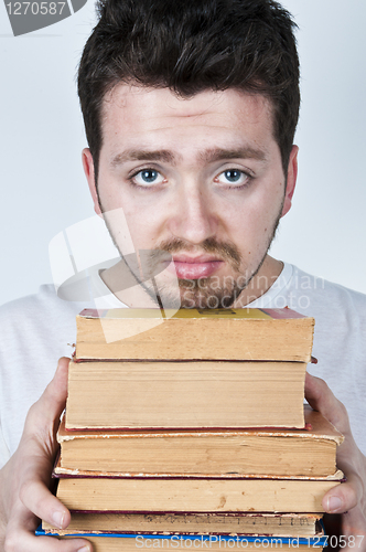 Image of Young man holding books