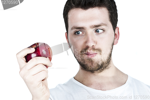 Image of Young man straing at an apple