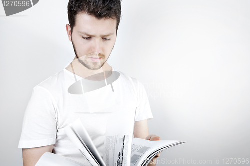 Image of Young man reading a book