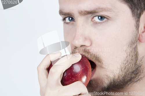 Image of Young Man Eating Apple