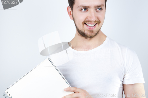 Image of Blonde Male Holding a Notebook