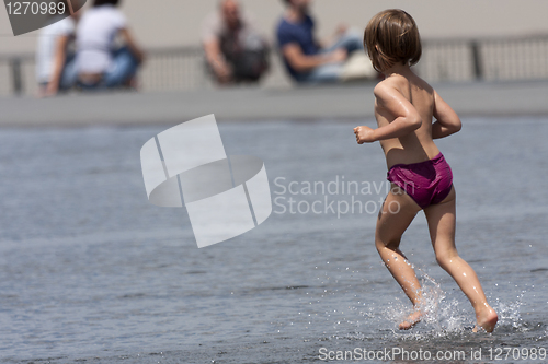 Image of Child running in the water.