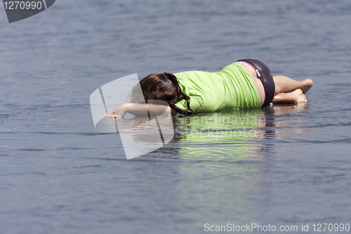 Image of Child lying in the water. 