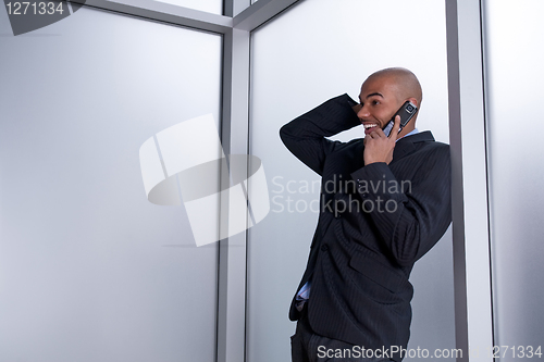 Image of Expressive businessman talking on his cell phone