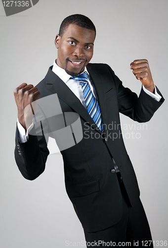 Image of Smiling handsome businessman showing his strength