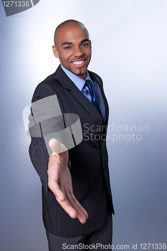 Image of Smiling businessman giving hand