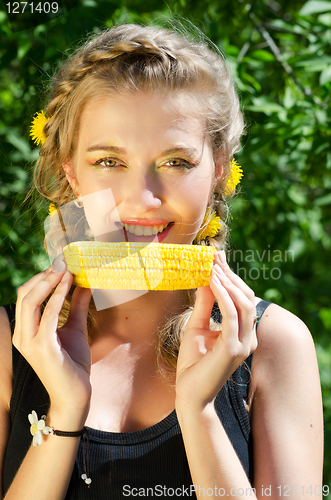 Image of woman eating corn-cob