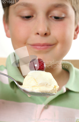 Image of Boy with ice cream and cherry on top