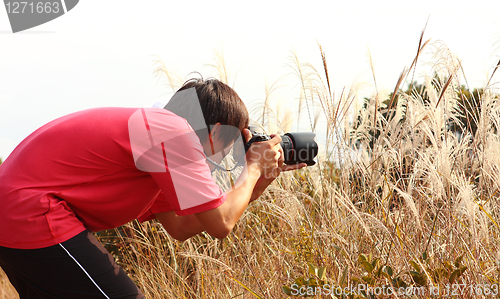 Image of photographer taking photo in country side 