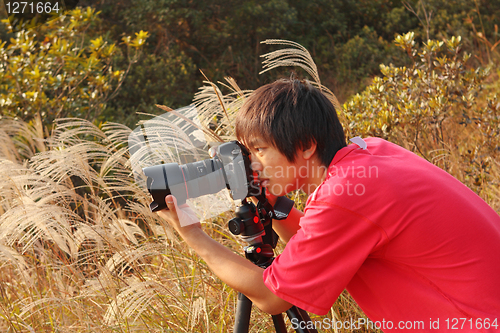 Image of photographer taking photo in country side 