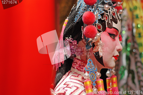 Image of chinese opera dummy and red cloth as text space ,it is a toy,not