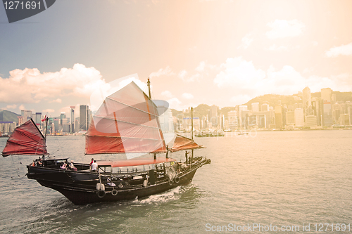 Image of Junk boat with tourists in Hong Kong Victoria Harbour