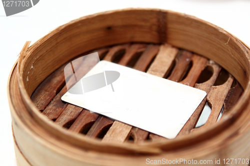 Image of White card in chinese bamboo steamer 