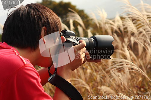 Image of photographer taking photo in country side 