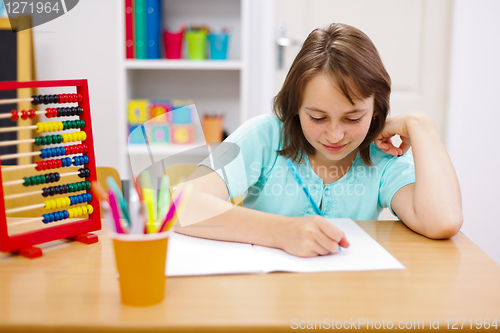 Image of Teen girl practicing and doing homework