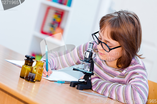 Image of Teen science girl with microscope