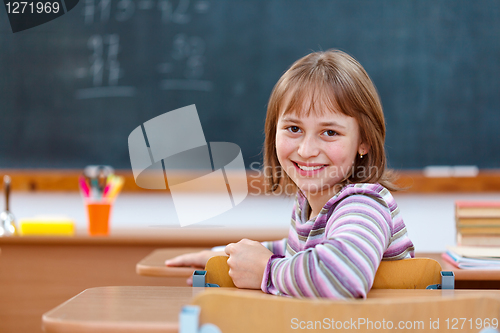 Image of Elementary school girl turning back and smiling