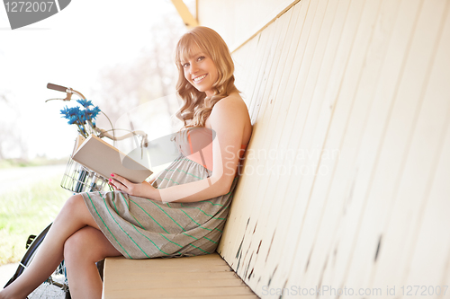 Image of Beautiful Caucasian woman reading outdoor