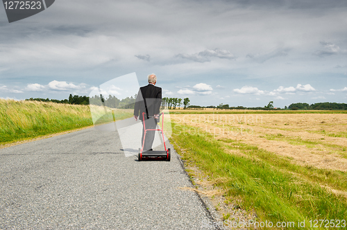 Image of Businessman and his Lawn mower