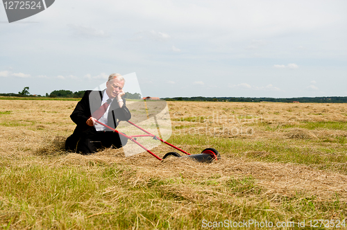 Image of Businessman and his Lawn mower