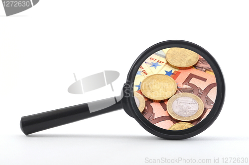 Image of money behind megnifying glass