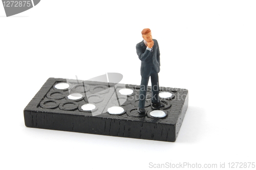 Image of business man on domino isolated