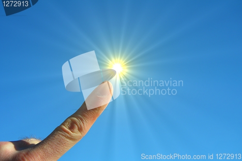 Image of hand fingers sky and sun