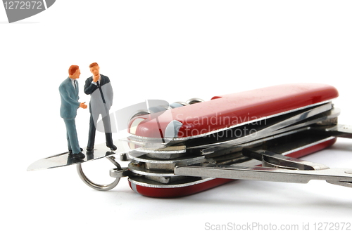 Image of business people on penknife