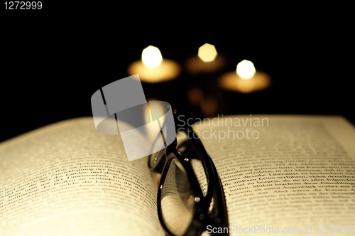 Image of book candle and glasses