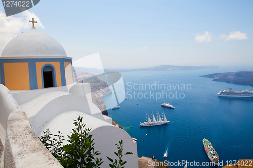 Image of Old church dome and view of boats in Santorini