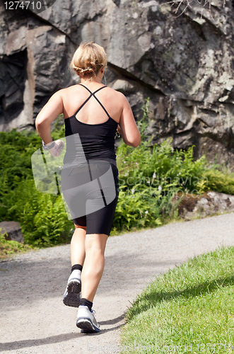Image of fat woman running around in the park