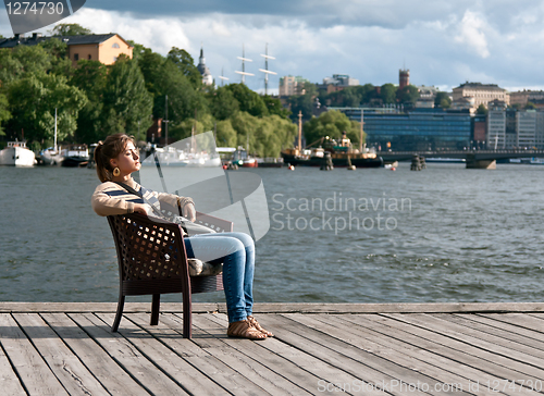 Image of girl sitting in the pier