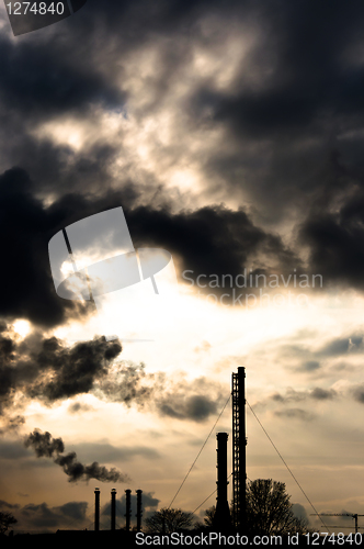 Image of Silhouette of a power plant against evening sky