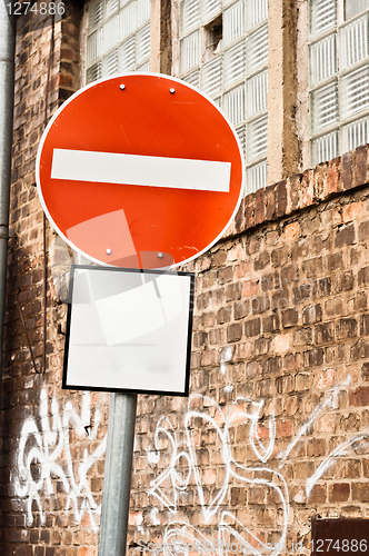 Image of Prohobition traffic sign against abandoned industrial background