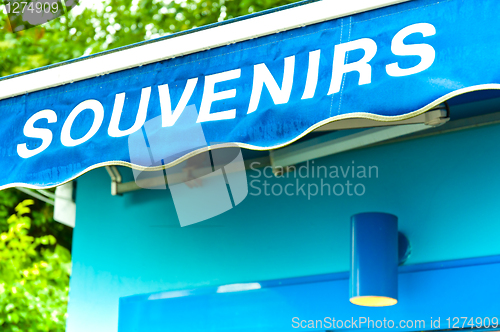 Image of souvenirs sign on wet blue surface